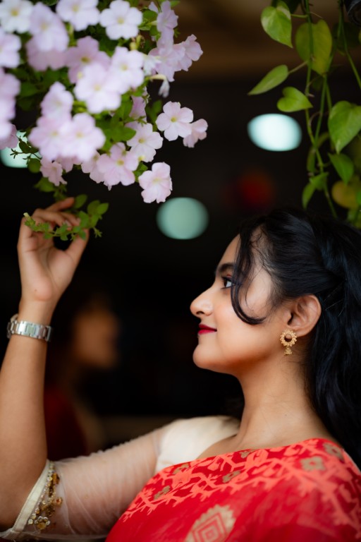 Bengali Woman in Red Saree Admiring Flowers - Portrait