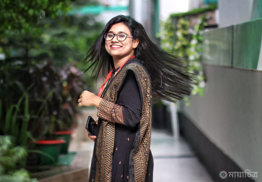 smiling woman black dress glasses